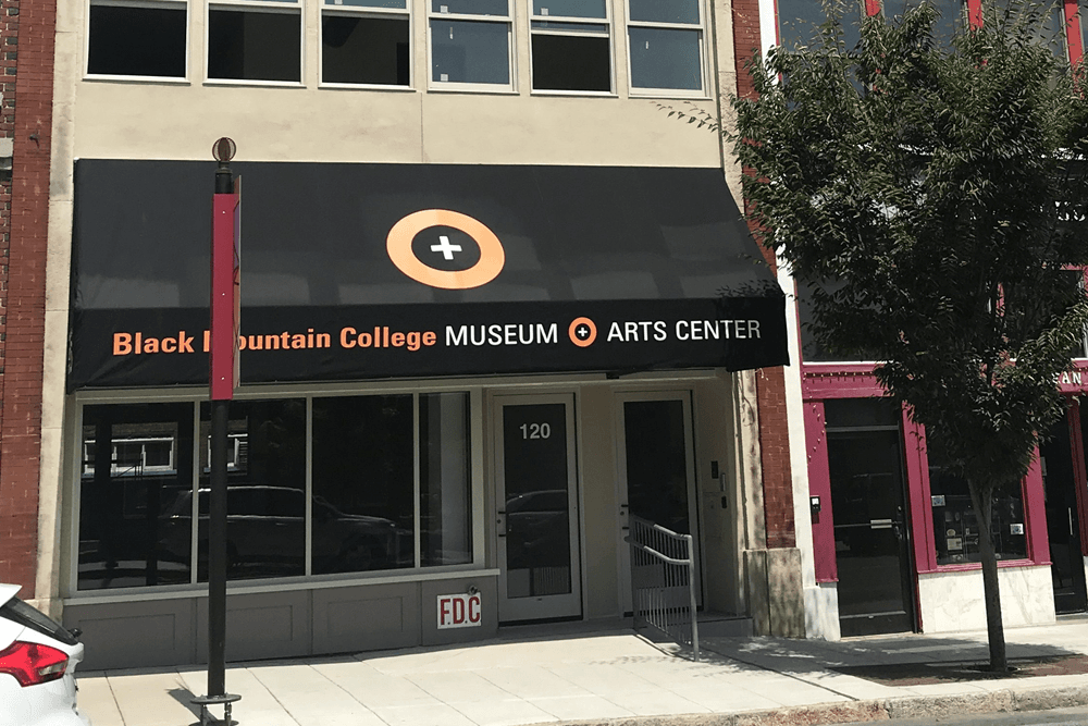 Exterior of the Black Mountain College Museum Arts Center, featuring a prominent awning with the center's name.